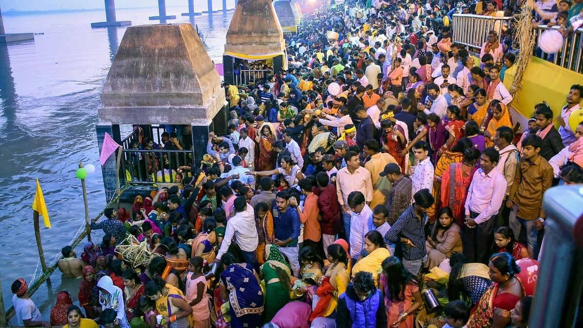 Devotees gather at the bank of Ganga River to offer prayers to the rising Sun during Chhath Puja celebrations, in Patna. Credit: PTI Photo