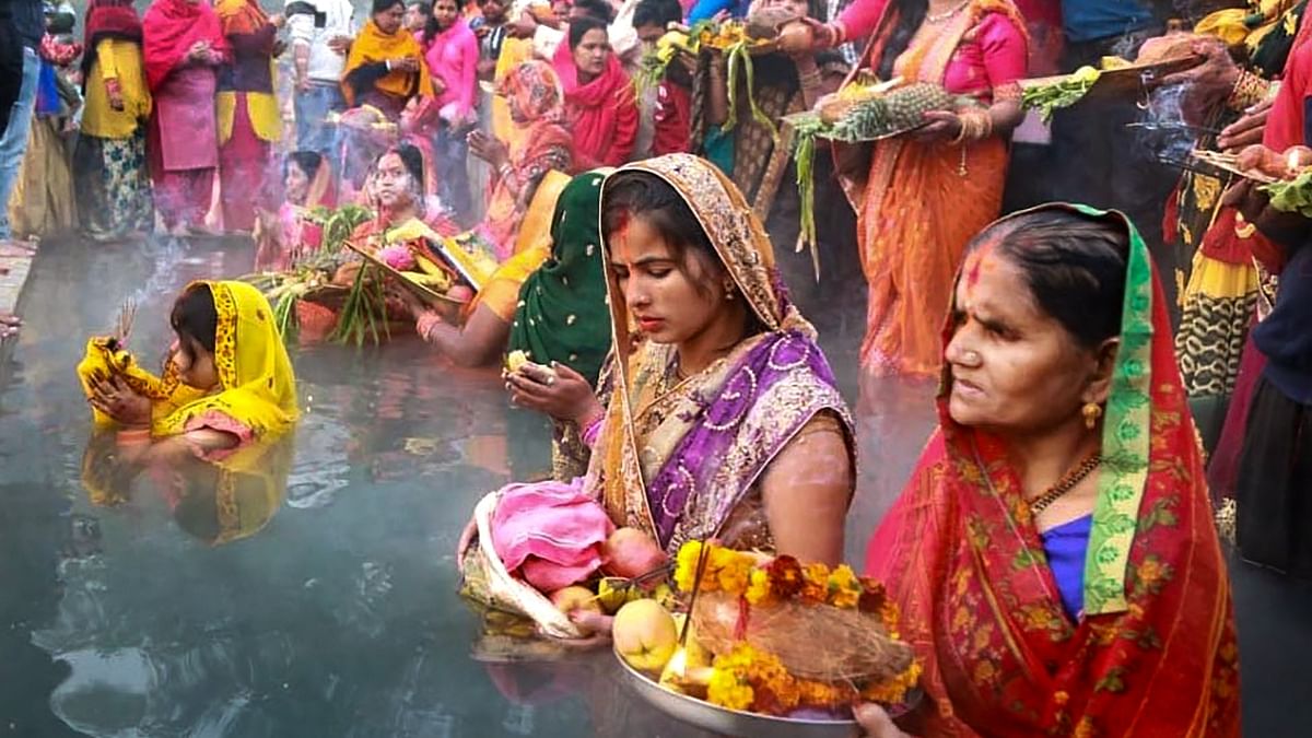 Devotees perform rituals during Chhath Puja, in Patiala. Credit: PTI Photo