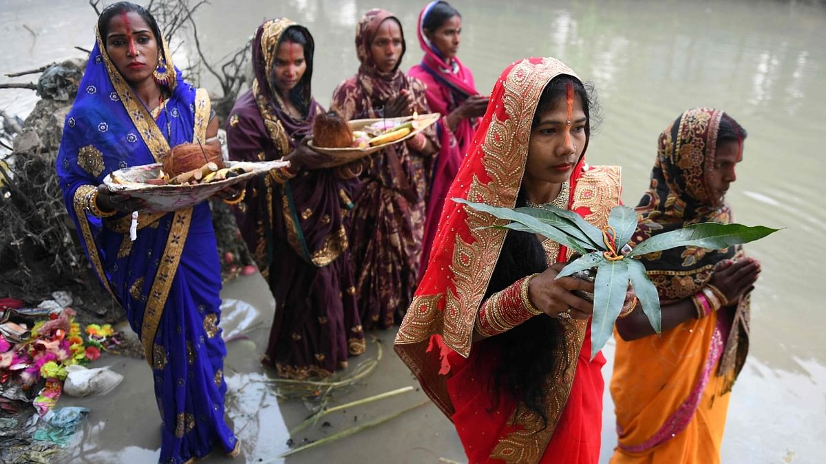 Devotees perform rituals during the last day of the Chhath Puja festival along a river on the outskirts of Amritsar. Credit: AFP Photo