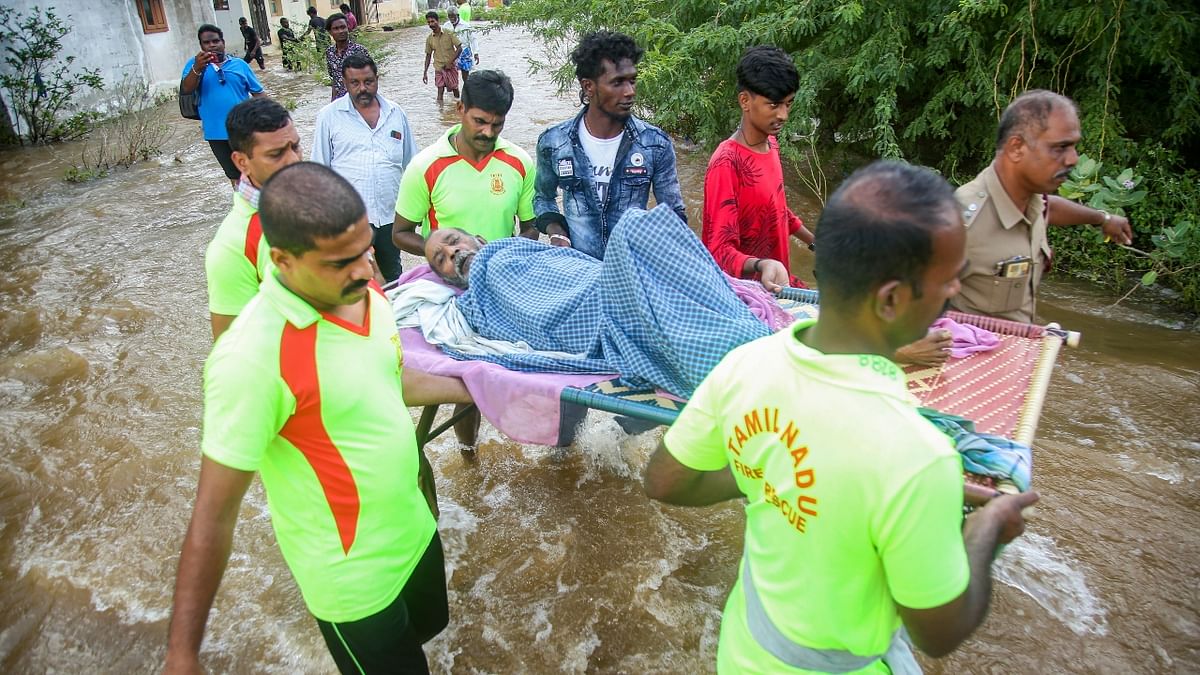 Firefighters evacuate people from a flooded area after heavy rain in Kanyakumari. Credit: PTI Photo