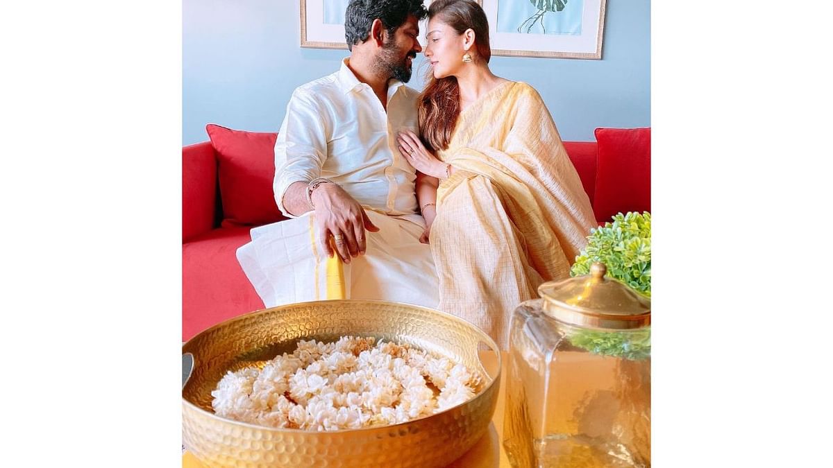 Vignesh in a white traditional attire and Nayanthara in a bright saree look good together in this priceless photo Credit: Instagram/wikkiofficial