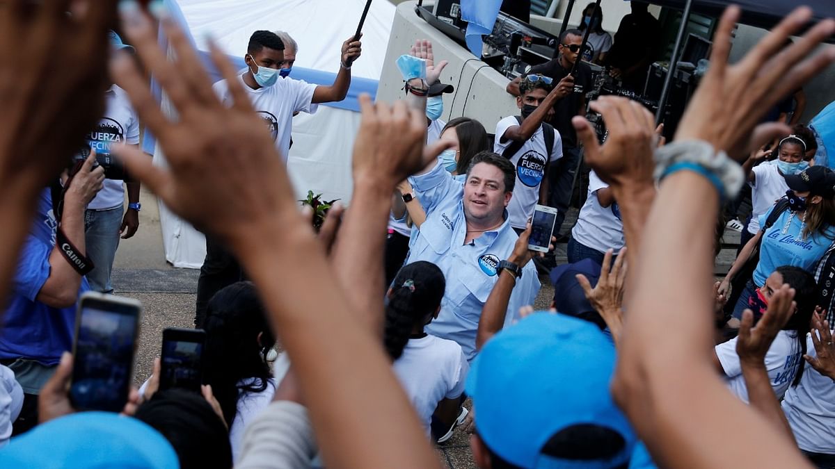 Gustavo Duque, the opposition candidate for Chacao Mayor, greets supporters during his closing campaign rally ahead of the regional elections with opposition parties returning to the polls, in Caracas, Venezuela. Credit: Reuters Photo