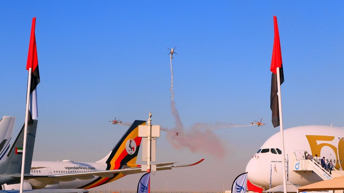 LCA Tejas, Suryakiran and Sarang aerobatics team showcase a coordinated display on the opening day of the Dubai Air Show. Credit: Twitter/@IAF_MCC