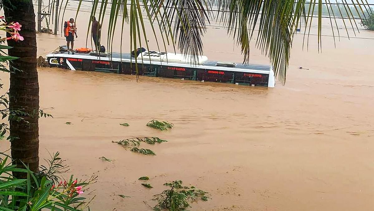 Swollen rivers and rivulets caused a huge deluge in the districts, cutting off roads at some places. In many places, roads turned into canals and swept vehicles away. In this photo, a bus is seen completely submerged in water. Credit: PTI Photo