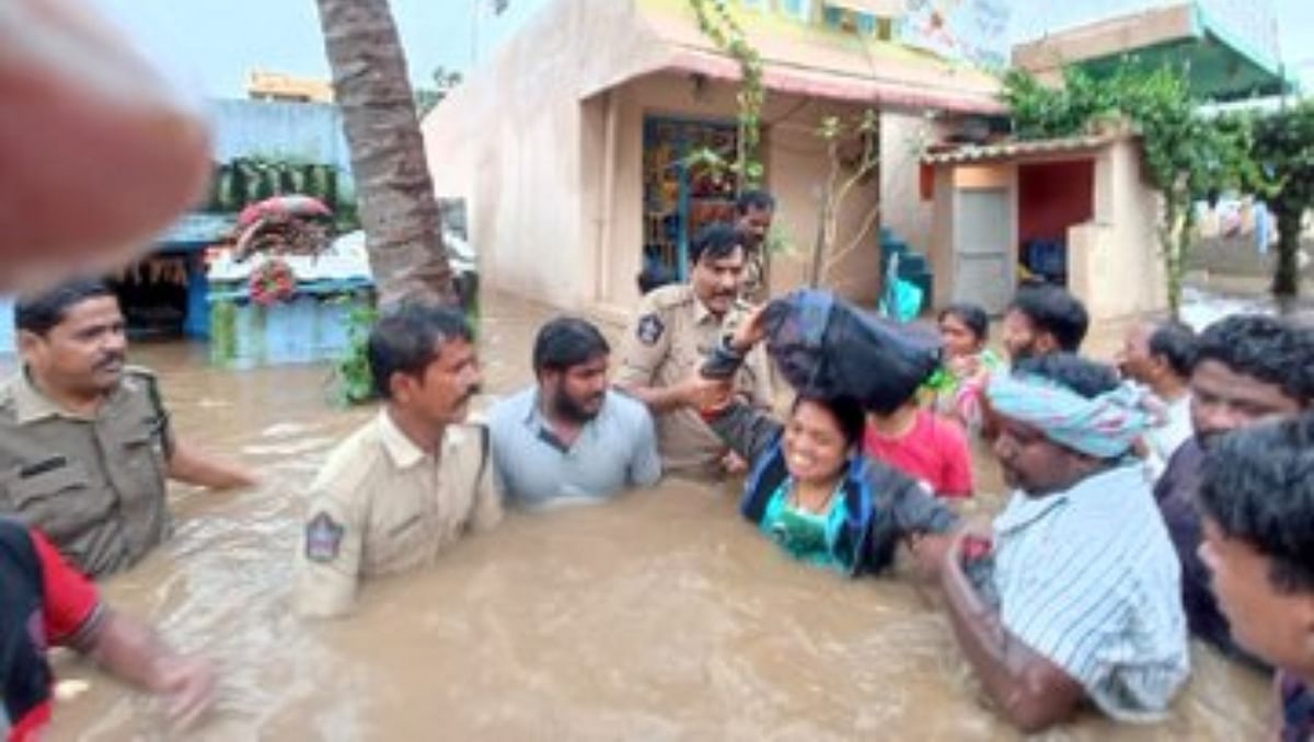 Police personnel are seen evacuating residents of Puttaparthi Sai Nagar colony to safer areas. Credit: Twitter/@dineshakula