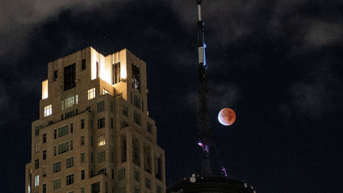 A partial lunar eclipse dubbed the 'blood' moon is seen next to the antenna on top of One World Trade Center in New York City, New York. Credit: Reuters Photo