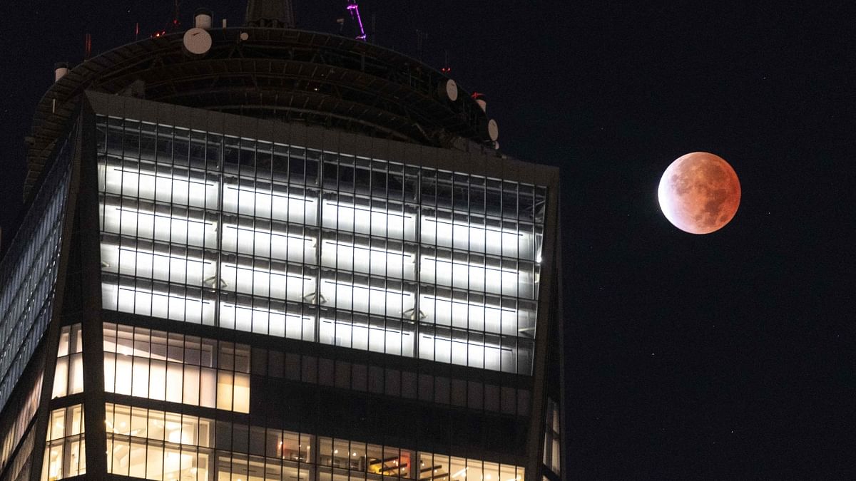 The moon is seen during a lunar eclipse next to the One World Trade Center in New York. Credit: AFP Photo