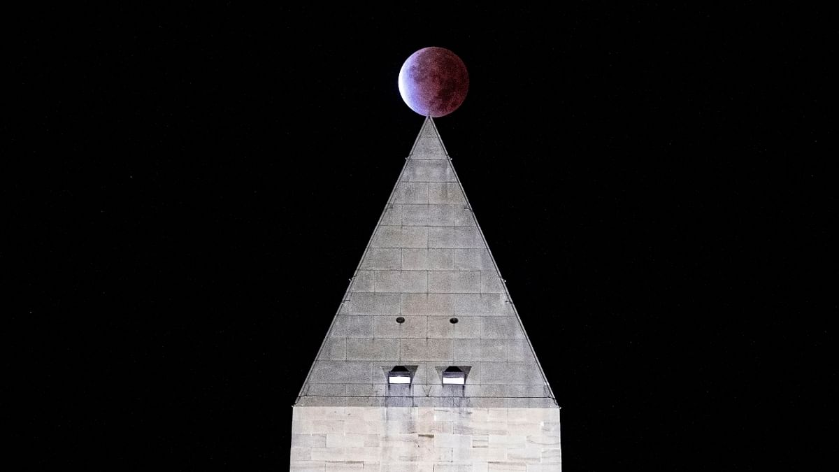 The Beaver 'blood' Moon partial lunar eclipse is seen above the Washington Monument in Washington, US. Credit: Reuters Photo