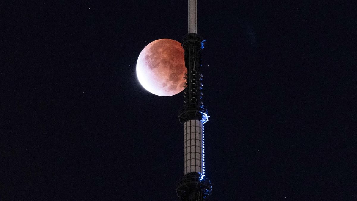The moon is seen during a lunar eclipse behind the One World Trade Center in New York. Credit: AFP Photo