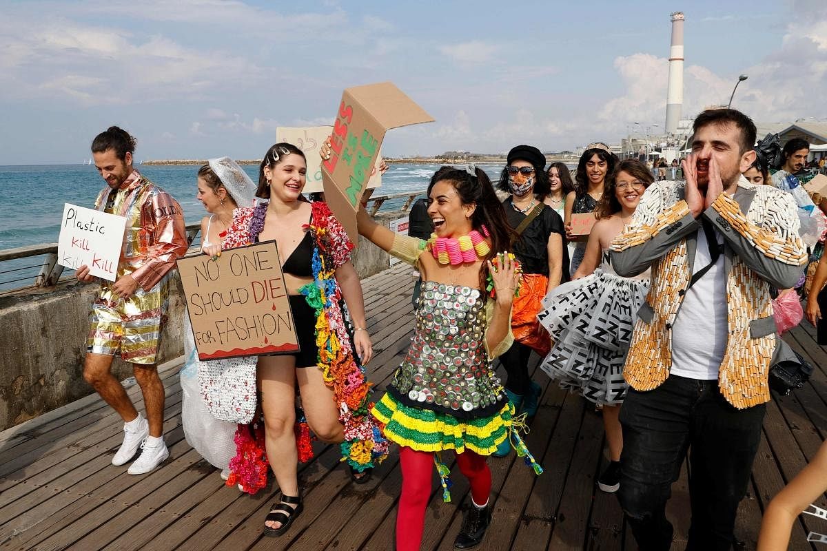 Models wearing clothes made from all kinds of garbage are pictured in the Israeli city of Tel Aviv as part of an event of called by the NGO Fashion Revolution to raise awareness on environmental issues. Credit: AFP Photo