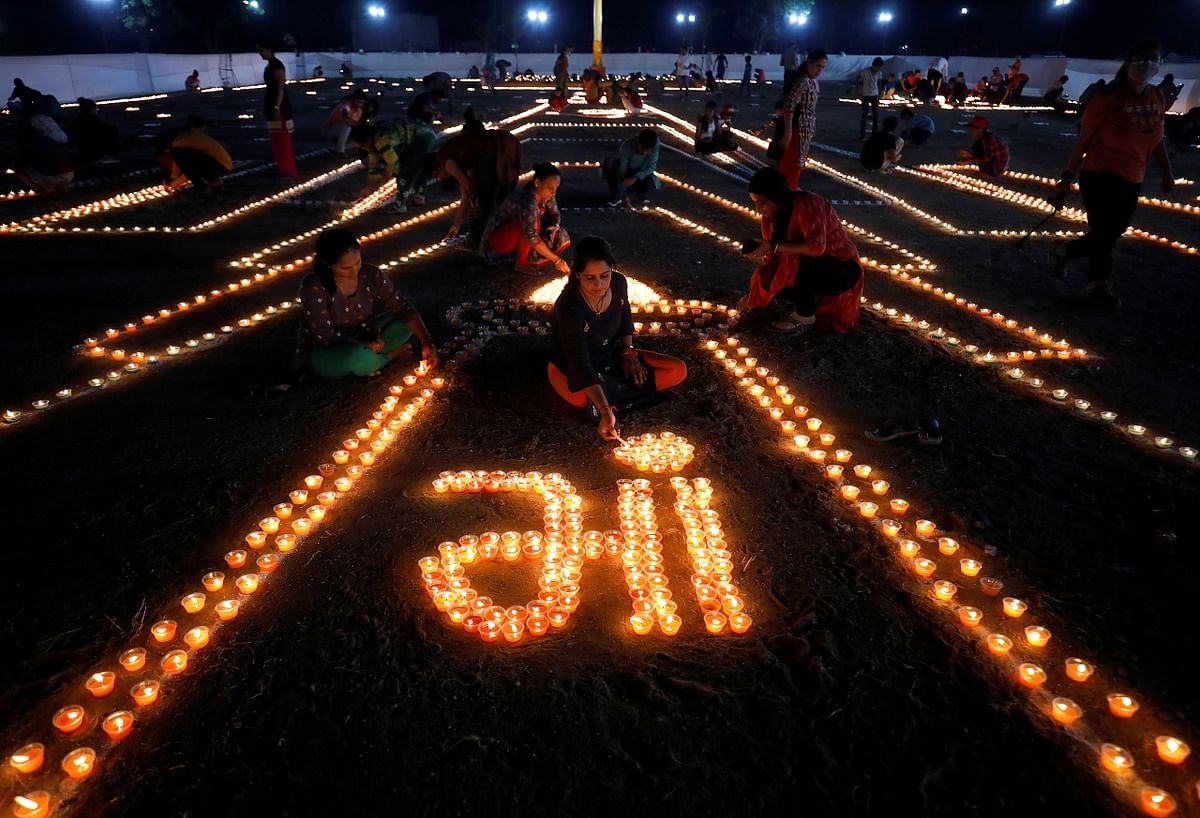 Hindu devotees light lamps during the ground breaking ceremony for Vishwa Umiya Dham temple on the outskirts of Ahmedabad. Credit: Reuters Photo