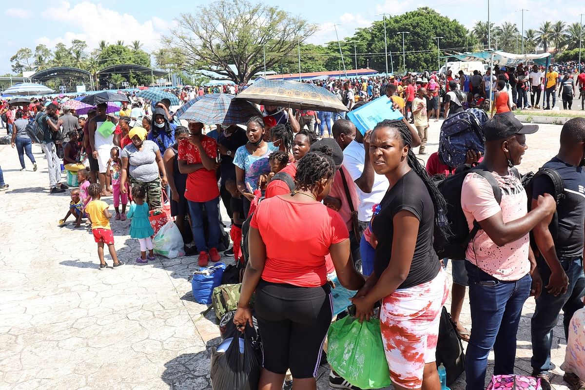 Migrants, mostly Haitians, queue outside a stadium to apply for humanitarian visas to be able to cross through Mexican territory to reach the US border. Credit: Reuters Photo