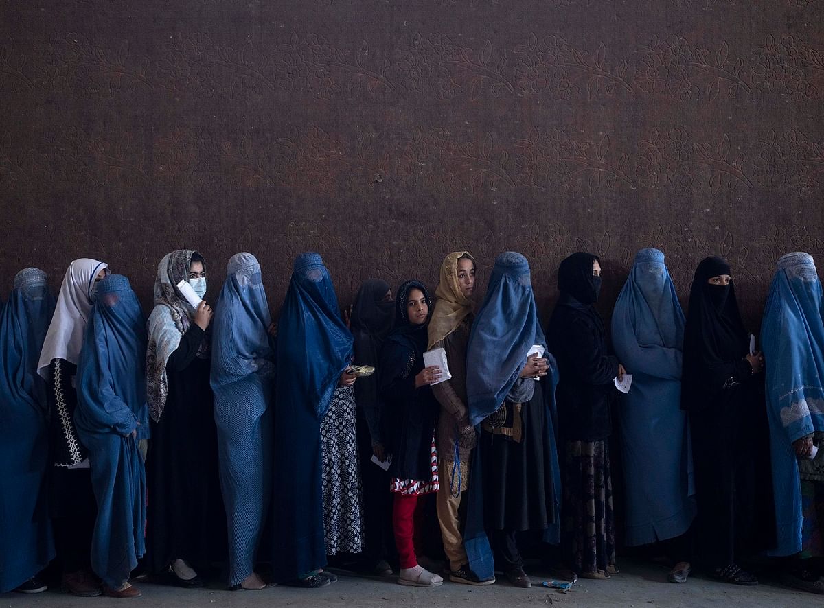 Women line up to receive cash at a money distribution point organized by the World Food Program, in Kabul, Afghanistan. Credit: AP Photo