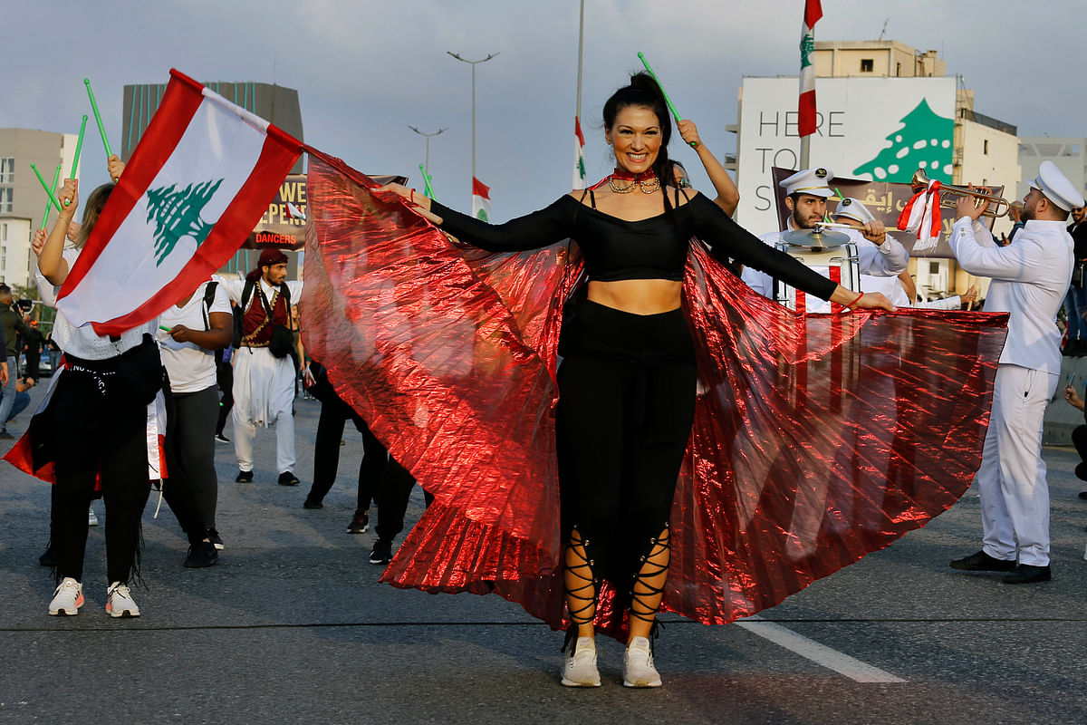 An anti-government protester dances during a parade to mark the 78th anniversary of Lebanon's independence from France. Credit: AP Photo