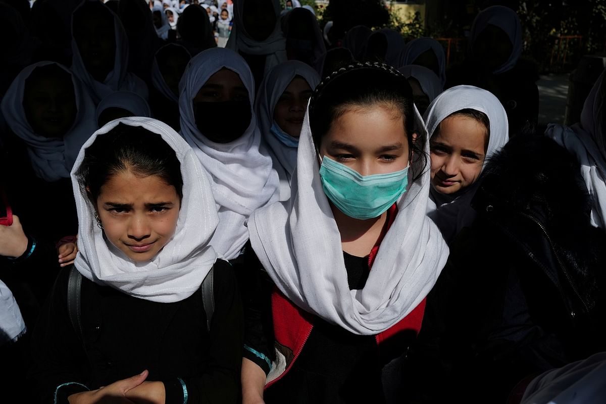 a 4th grade primary school student, leaves school after a class in Kabul, Afghanistan. Credit: Reuters Photo