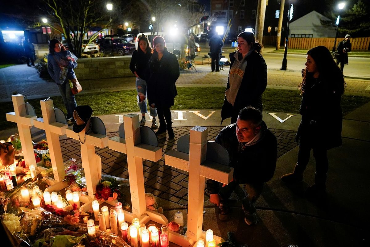 Community members observe a memorial after a car plowed through a holiday parade. Credit: Reuters Photo