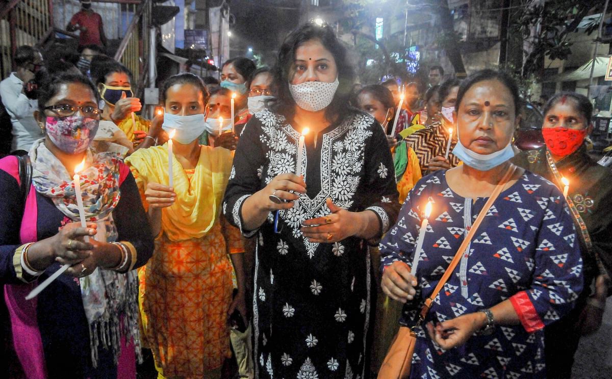 Trinamool Congress women activists participate in candle march to protest against the alleged attack on party leaders in Tripura. Credit: PTI Photo