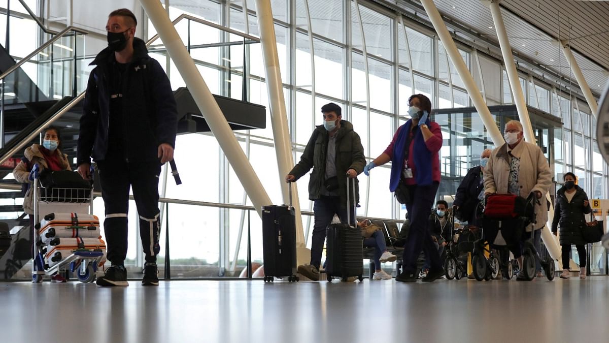 People walk inside Schiphol Airport after Dutch health authorities said that 61 people who arrived in Amsterdam on flights from South Africa tested positive for Covid-19, in Amsterdam, Netherlands. Credit: Reuters Photo