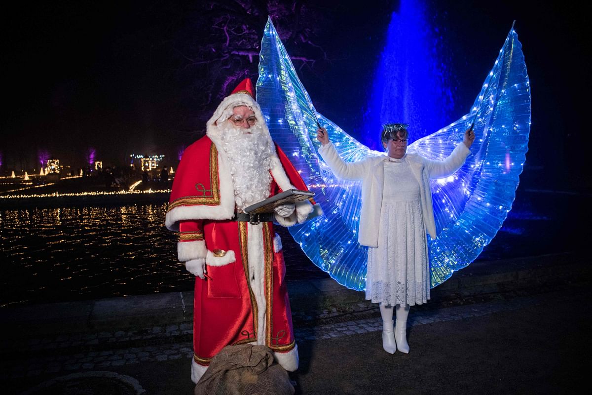 A man dressed as Santa Claus and a woman dressed as an angel pose for a photo during a Santa Claus General Assmbly at Tierpark in Berlin. Credit: AFP Photo