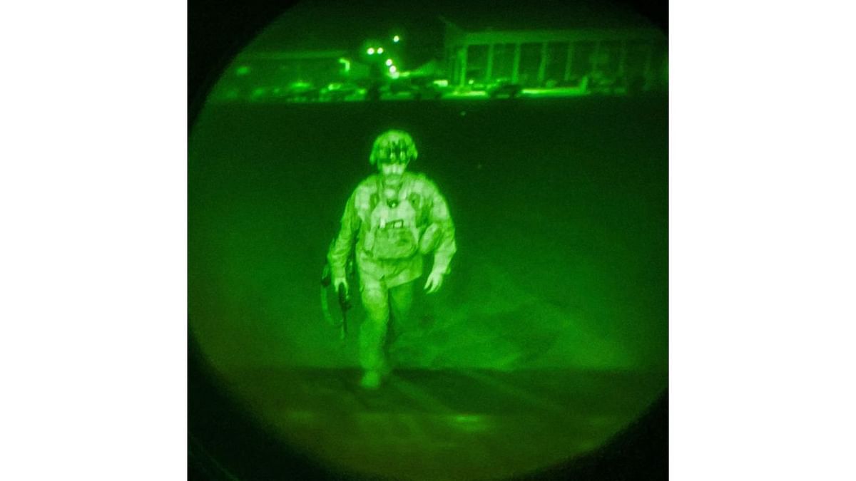 US Army Major General Chris Donahue, commander of the 82nd Airborne Division, steps on board a transport plane as what the XVIII Airborne Corps calls the last Soldier to leave Kabul, Afghanistan on August 30, in a photograph using night vision optics. Credit: Reuters Photo