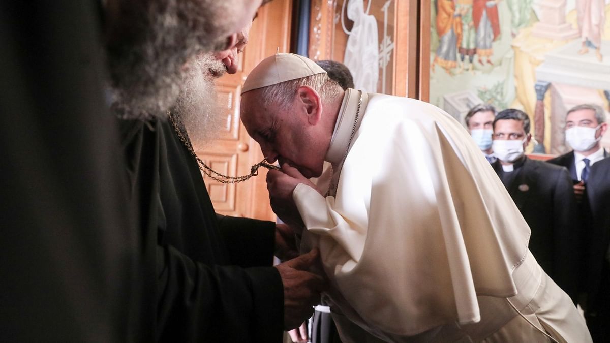 Pope Francis kisses an encolpion as he meets with Greek Orthodox church Archbishop Ieronimos at the Orthodox Archbishopric of Greece, in Athens, Greece. Credit: Reuters Photo