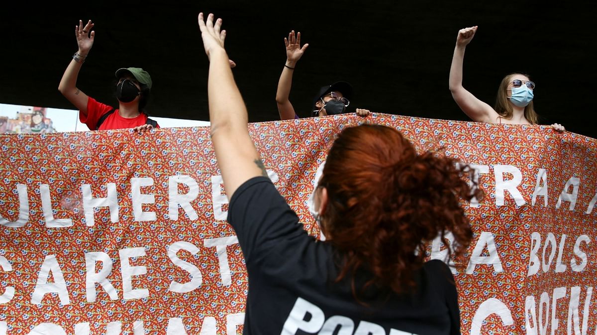 Demonstrators lift a banner as they participate in a protest against Brazil’s President, Jair Bolsonaro, in Sao Paulo, Brazil. Credit: Reuters Photo