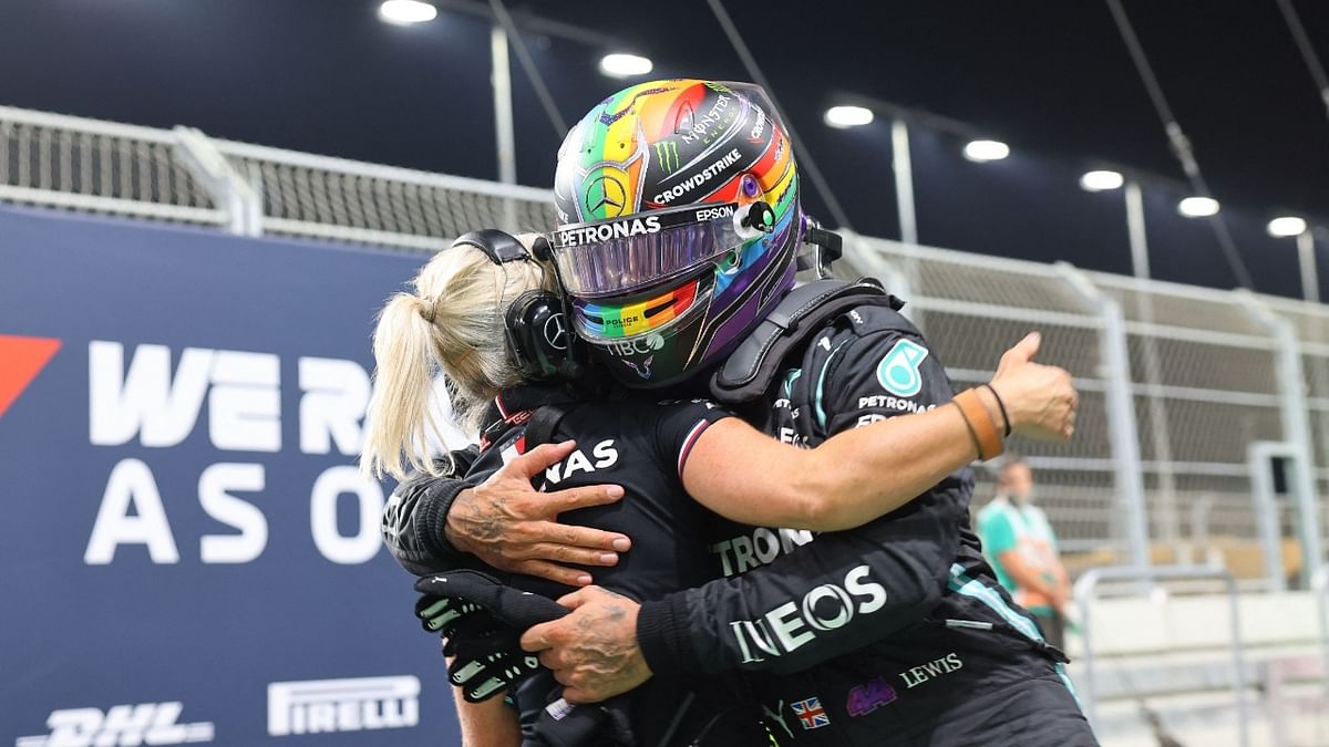 Mercedes' British driver Lewis Hamilton celebrates with a team members in the parc ferme after taking pole position in the qualifying session of the Formula One Saudi Arabian Grand Prix at the Jeddah Corniche Circuit in Jeddah. Credit: AFP Photo