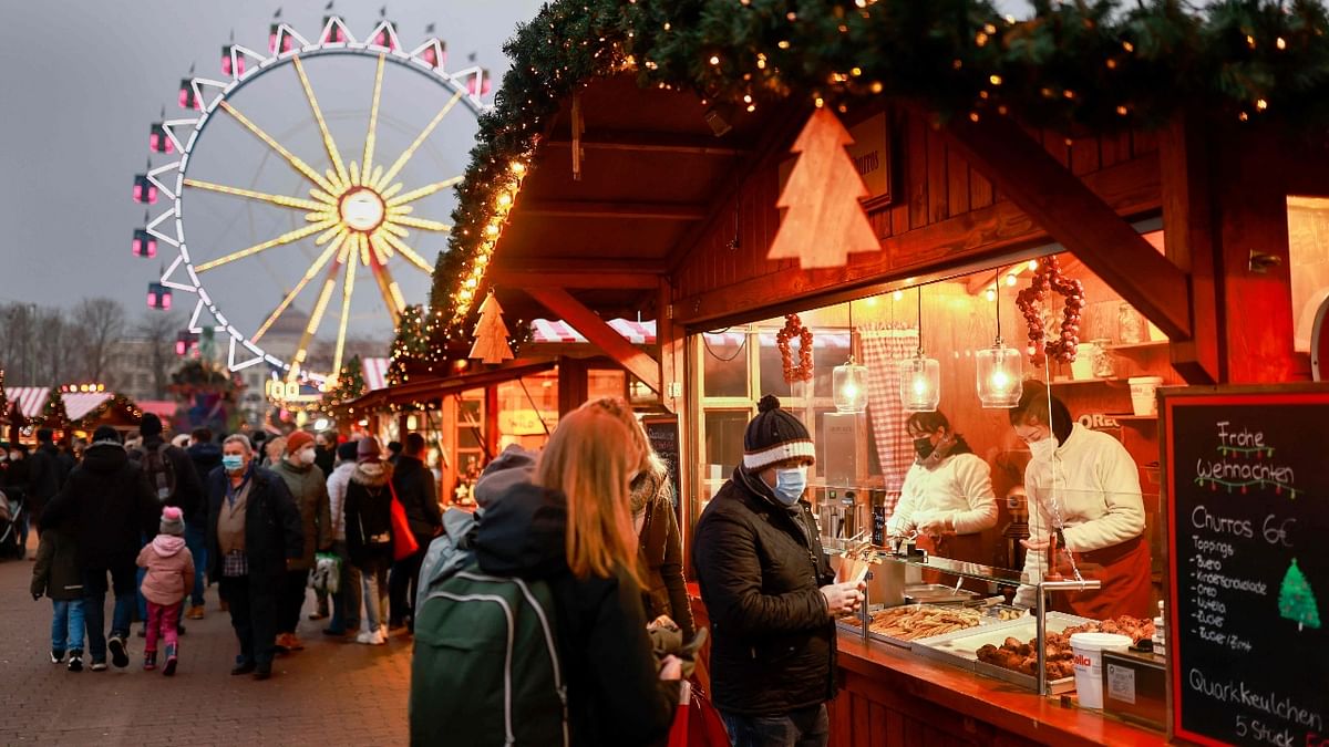 Visitors queue for a sweet Chrsitmas treat at a stall at the Berlin town hall (Rote Rathaus) Christmas market near Alexanderplatz in Berlin. Credit: Reuters Photo