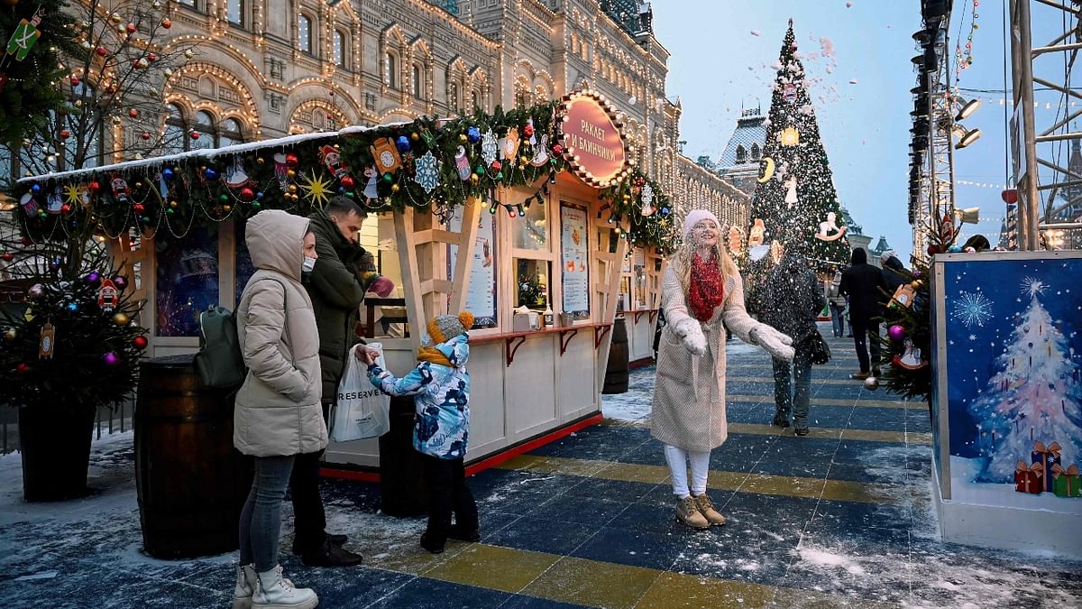 A woman poses for pictures at a New Year and Christmas market in Red Square in downtown Moscow. Credit: AFP Photo