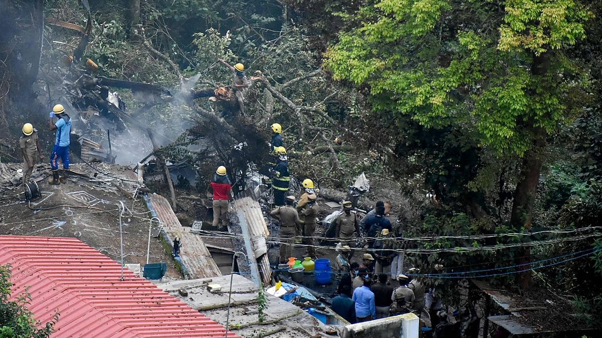 Firemen and rescue workers try to control the fire in the burning debris of an IAF Mi-17V5 helicopter crash site in Coonoor, Tamil Nadu. Credit: AFP Photo