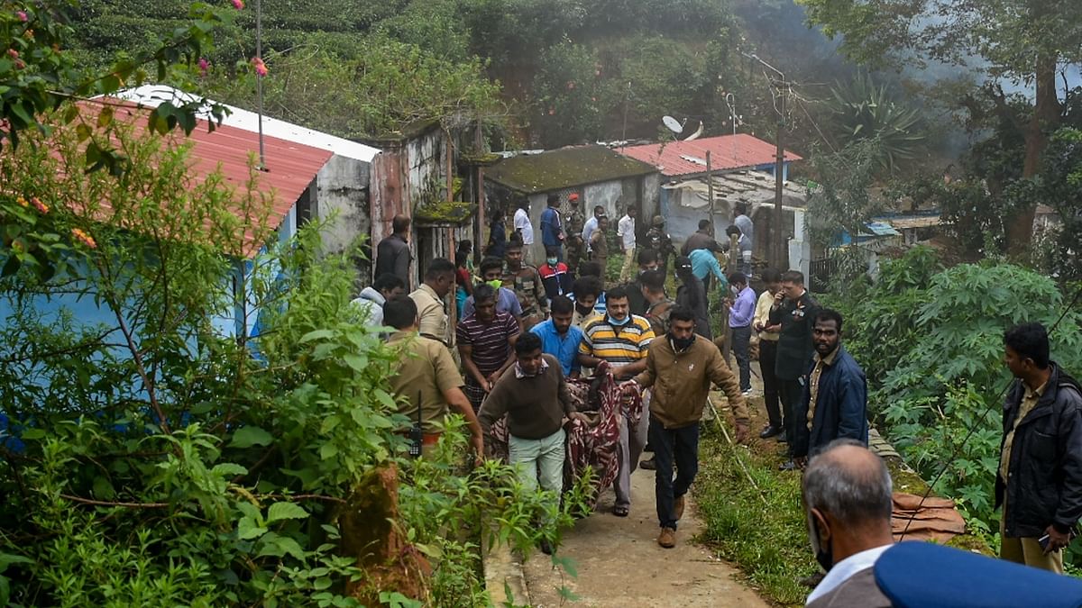 People help carry body of one of the victims from near the site of an IAF Mi-17V5 helicopter crash in Coonoor, Tamil Nadu. Credit: AFP Photo