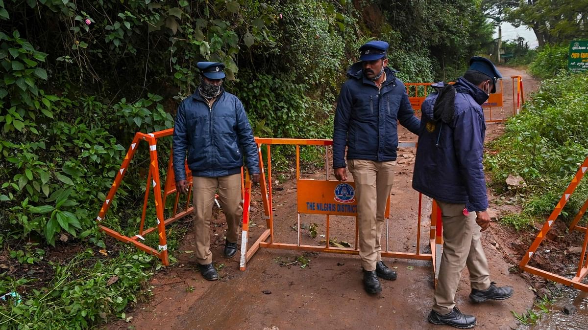 Security personnel guard a roadblock to the site a day after an army helicopter crashed in Coonoor, Tamil Nadu. Credit: AFP Photo