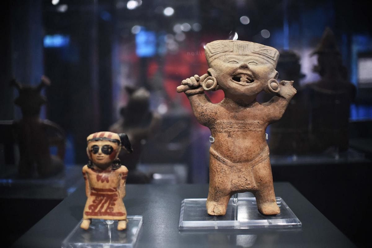Veracruz terracottas “Smiling Faces” dating from 100 to 1000 DC are exhibited at the Tlatelololco University Cultural Center in Mexico City. Credit: AFP Photo