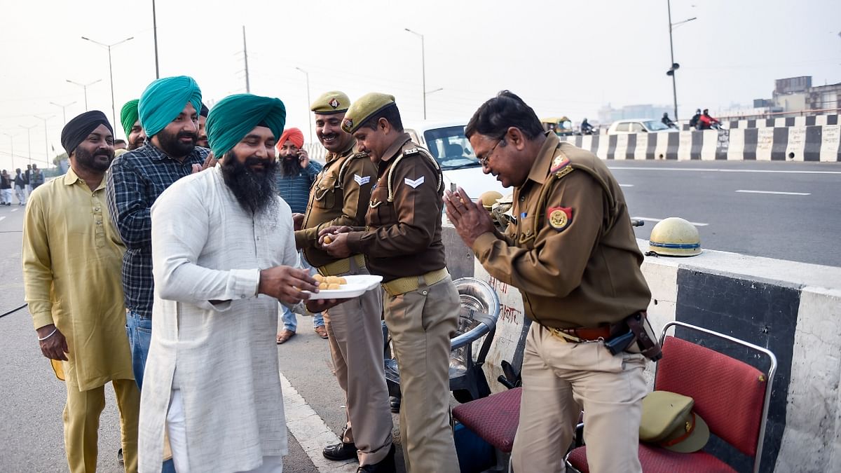 At the Ghazipur border, they offered sweets to the police personnel deployed at the protest site. Credit: PTI Photo