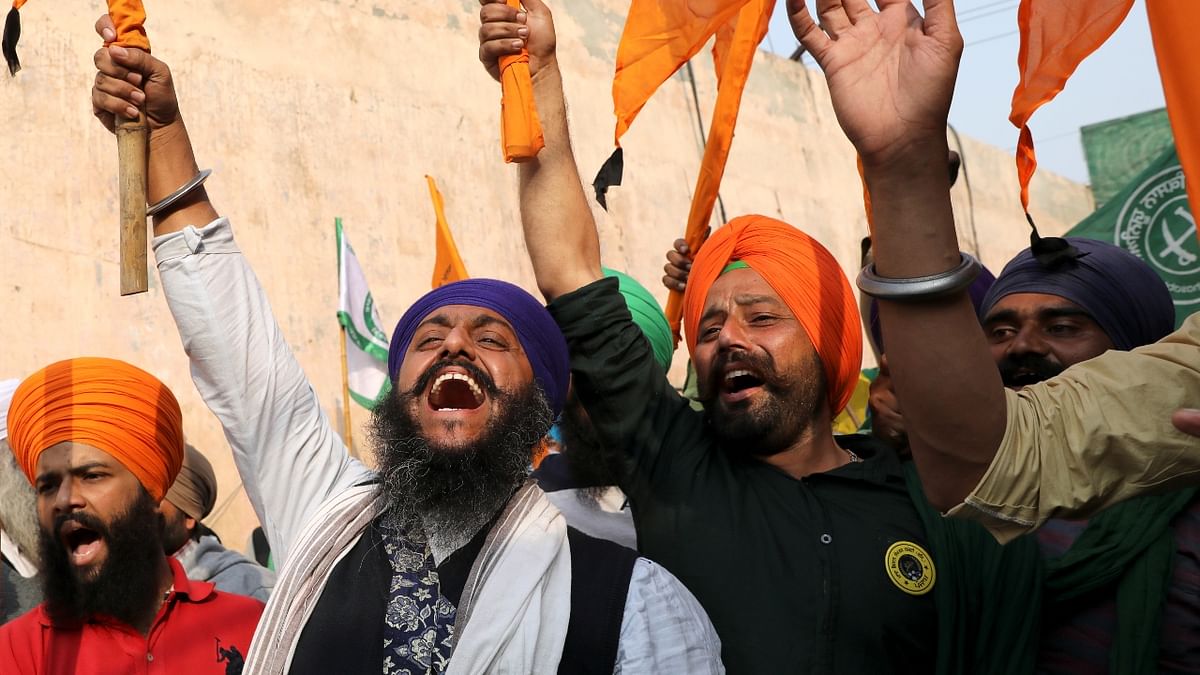 Singhu and Ghazipur border protest sites erupted into celebrations with farmers raising union flags, greeting each other on the success of their agitation and playing patriotic songs. Credit: Reuters Photo