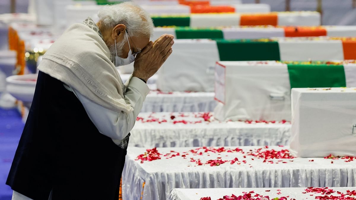 Prime Minister Narendra Modi pays homage next to the coffin containing the mortal remains of India's Chief of Defence Staff General Bipin Rawat, at an airport in New Delhi. Credit: Reuters Photo