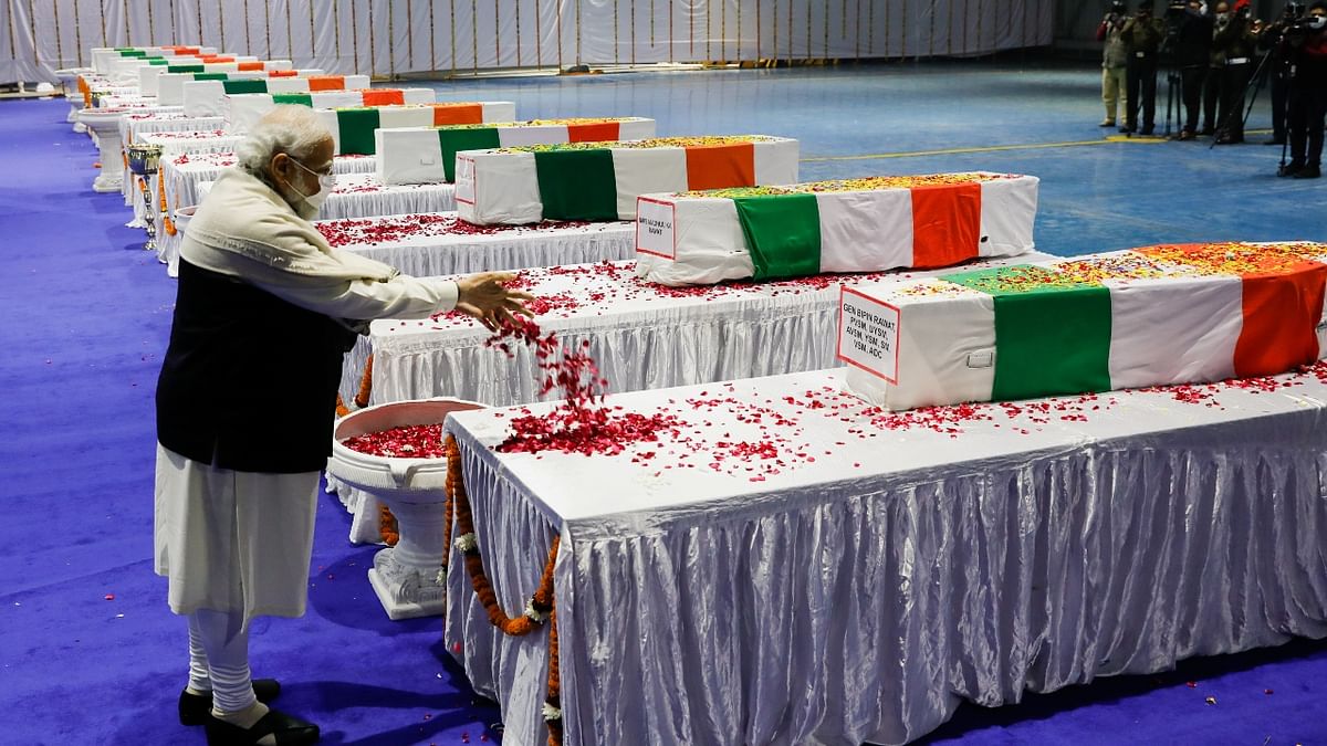 Prime Minister Narendra Modi pays homage next to the coffin containing the mortal remains of India's Chief of Defence Staff General Bipin Rawat, at an airport in New Delhi. Credit: Reuters Photo