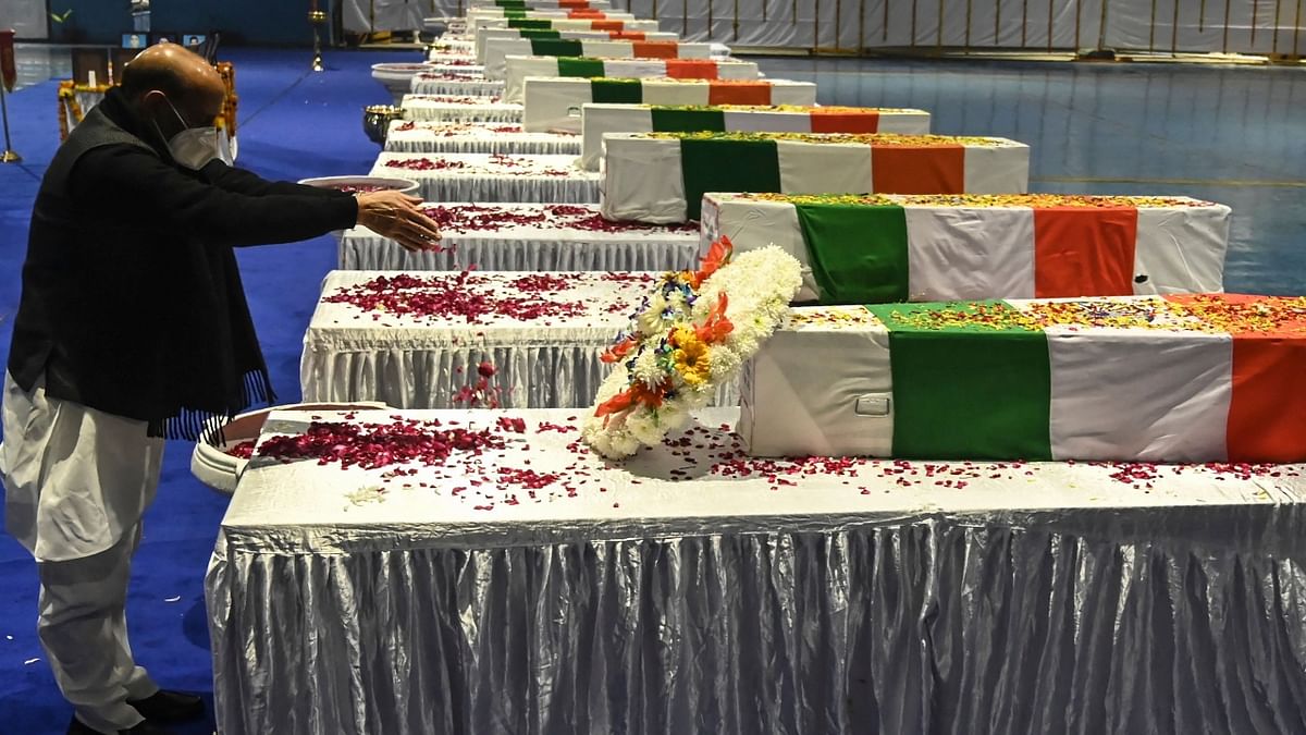 Defence Minister Rajnath Singh pays his tribute to Chief of Defence Staff Gen Bipin Rawat and other 12 victims who lost their lives in a helicopter crash a day earlier, during a tribute ceremony at Palam Air Force station in New Delhi. Credit: AFP Photo