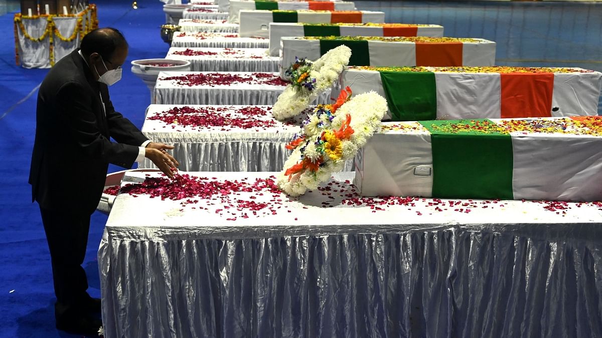 National Security Advisor Ajit Doval pays his tribute to Chief of Defence Staff Gen Bipin Rawat and other 12 victims who lost their lives in a helicopter crash a day earlier, during a tribute ceremony at Palam Air Force station in New Delhi. Credit: AFP Photo