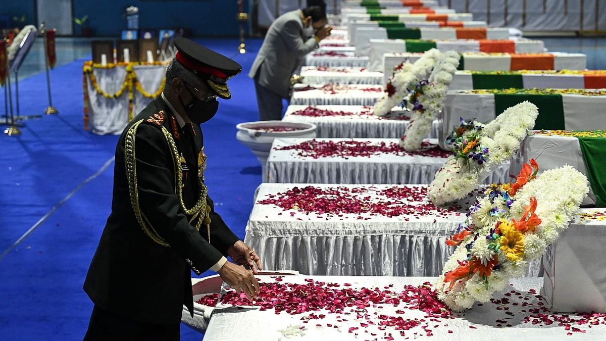 Army General Manoj Mukund Naravane pays his tribute to Chief of Defence Staff Gen Bipin Rawat and other 12 victims who lost their lives in a helicopter crash a day earlier, at Palam Air Force station in New Delhi. Credit: AFP Photo