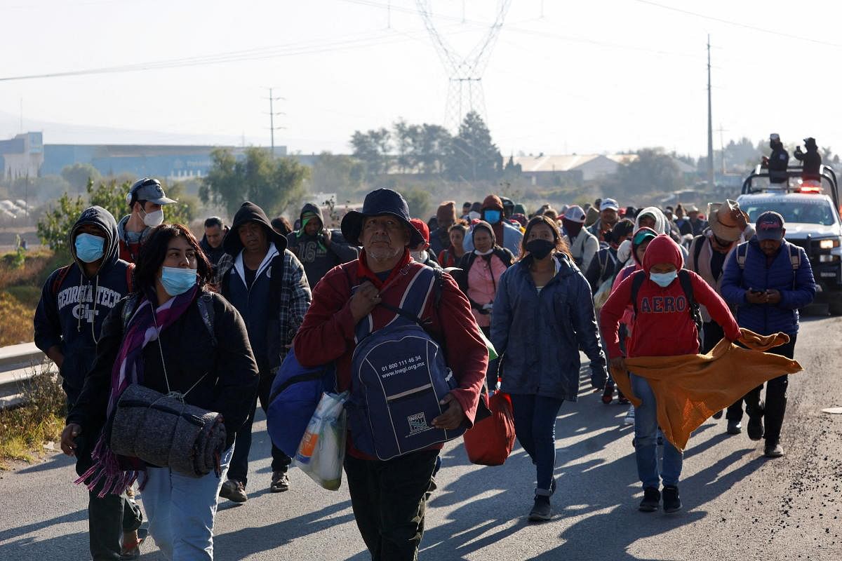 Migrants from Central America and Mexico walk along a highway in a caravan heading to Mexico City, in San Miguel Xoxtla, Puebla state, Mexico. Credit: Reuters Photo