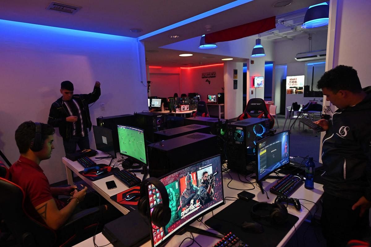 Young 'gamers' in Venezuela score virtual goals which were impossible in real life. Their worst rival: a poor Internet service. Credit: AFP Photo