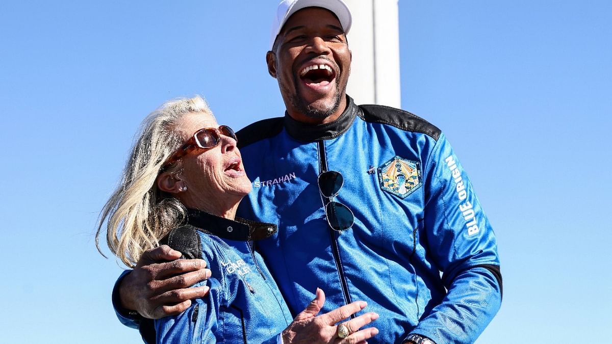 Good Morning America co-anchor and former NFL star Michael Strahan laughs with Laura Shepard Churchley, daughter of astronaut Alan Shepard, during a media availability on the landing pad after they flew into space aboard Blue Origin’s New Shepard. Credit: AFP Photo