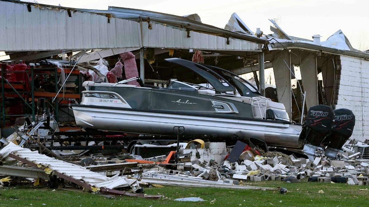 A boat sits at rest after being sucked out of a marine dealership by a tornado in Mayfield, Kentucky. Credit: AFP Photo