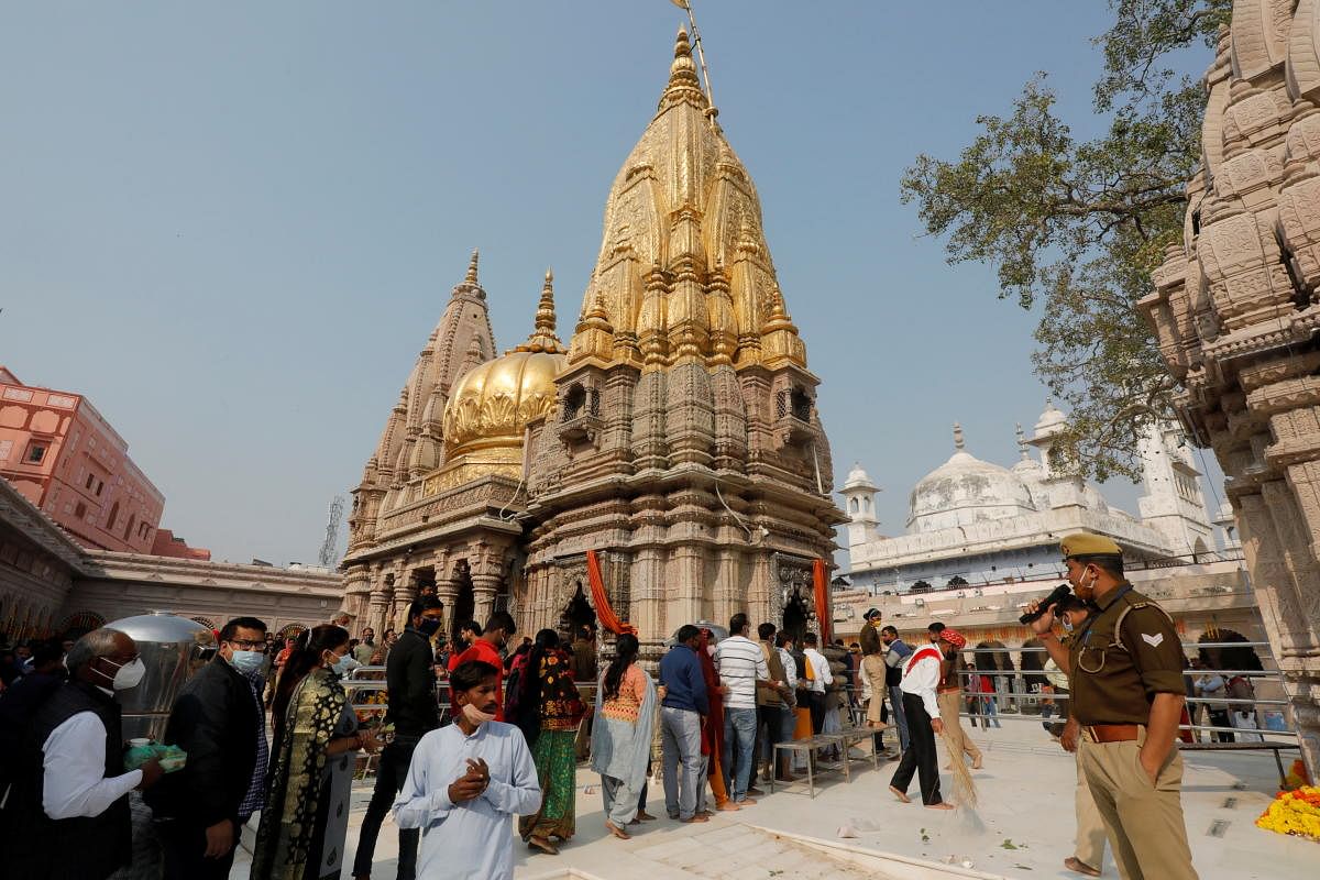 Devotees sing hymns inside Kashi Vishwanath Temple compound ahead of the inauguration of the new Kashi Vishwanath Temple corridor by Prime Minister Narendra Modi in Varanasi. Credit: Reuters Photo
