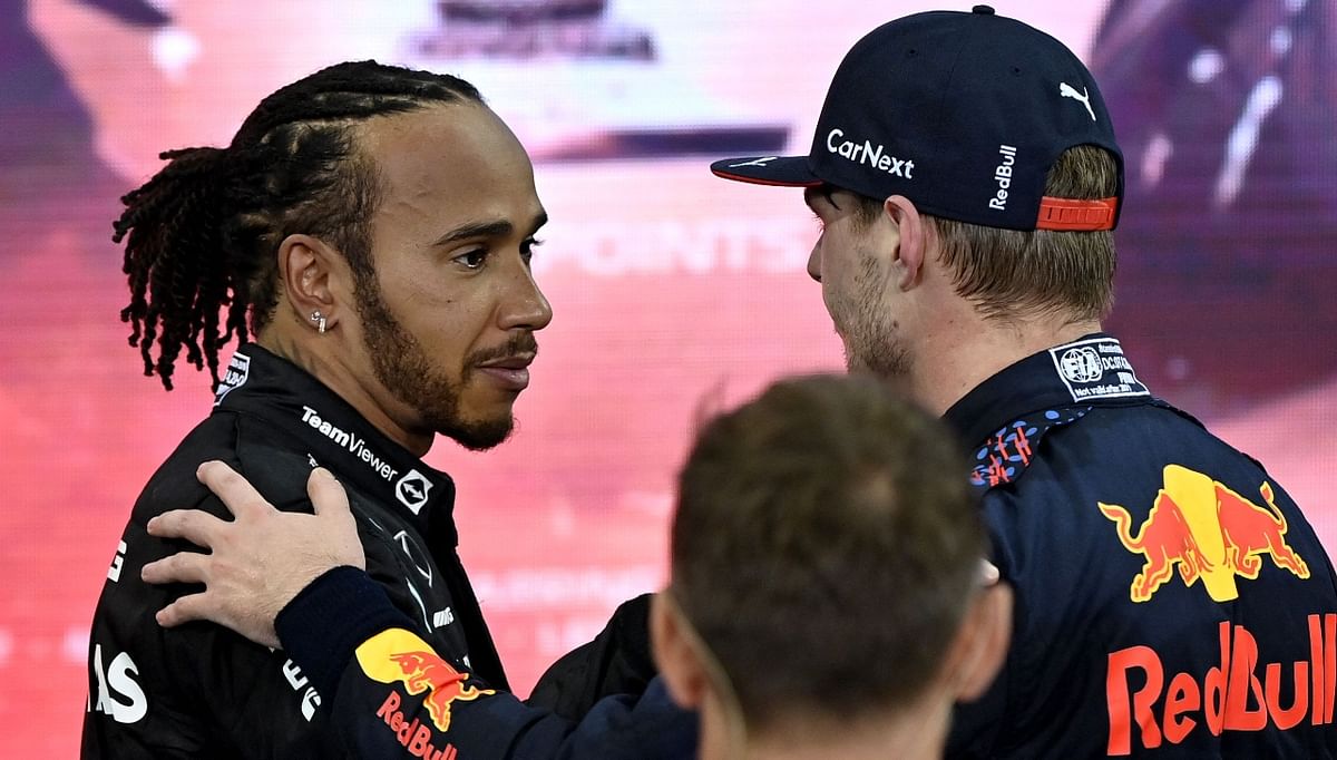 Lewis Hamilton is seen greeting 2021 FIA Formula One World Champion Red Bull's Dutch driver Max Verstappen post the race. Credit: AFP Photo