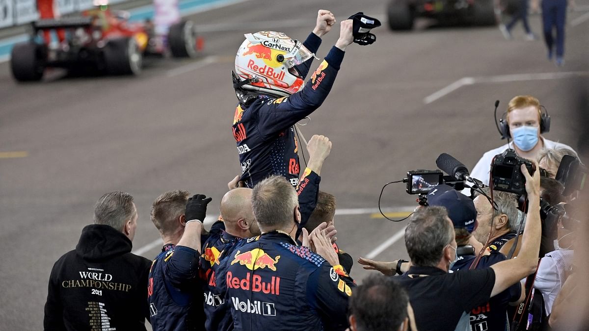 Red Bull's Dutch driver Max Verstappen celebrates in the parc ferme of the Yas Marina Circuit after winning the Abu Dhabi Formula One Grand Prix. Credit: AFP Photo