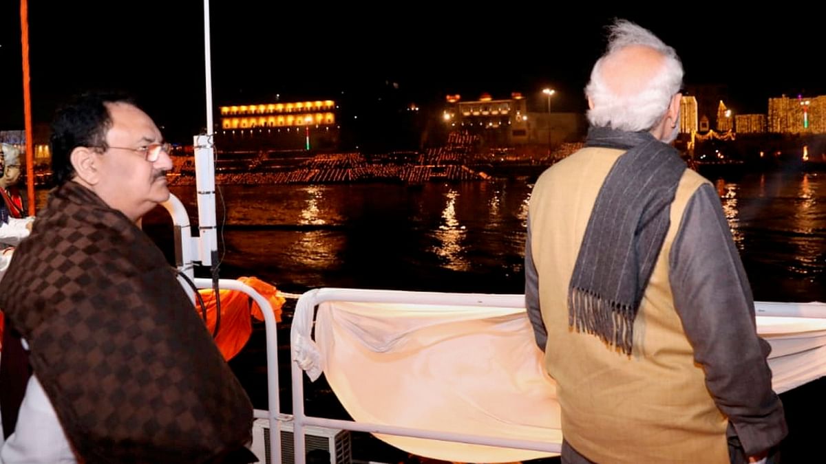 Prime Minister Narendra Modi and BJP National President JP Nadda watch the 'Ganga Aarti' from a ship, at Ganga Ghat in Varanasi. Credit: PTI Photo