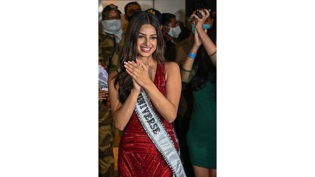 Miss Universe Harnaaz Sandhu gestures upon her arrival at the airport in Mumbai. Credit: AFP Photo