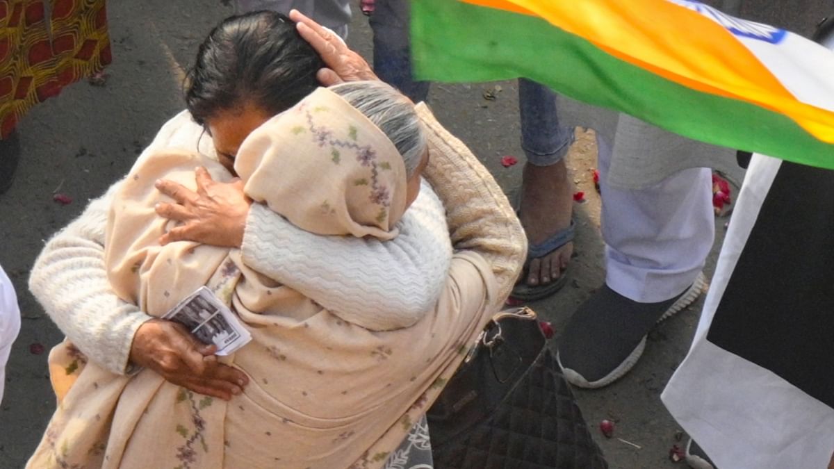 Farmer embrace each other at Ghazipur border as they prepare to leave after their year-long agitation against the contentious farm reform laws, in New Delhi. Credit: PTI Photo